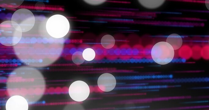 Shimmering bokeh circles and colored light streaks creating abstract studio background with grain