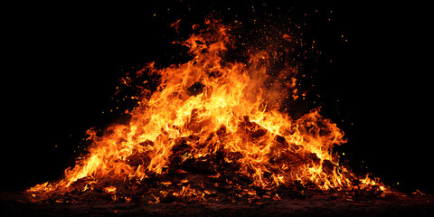 Roaring bonfire burns brightly against the night, sparks fly upward