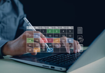 business professional using a digital calendar interface on a laptop to organize tasks, schedule deadlines, and improve time management, highlighting modern workflow and productivity planning.