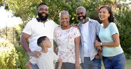 Family moving for portrait on sunlit lawn, camera zooming and animated guides highlighting faces - Powered by Adobe