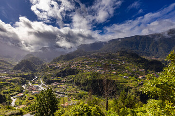 Naklejka premium Scenic Mountain Valley with Rural Village and Lush Green Hills, Madeira landscapes, nature background or travel wallpaper