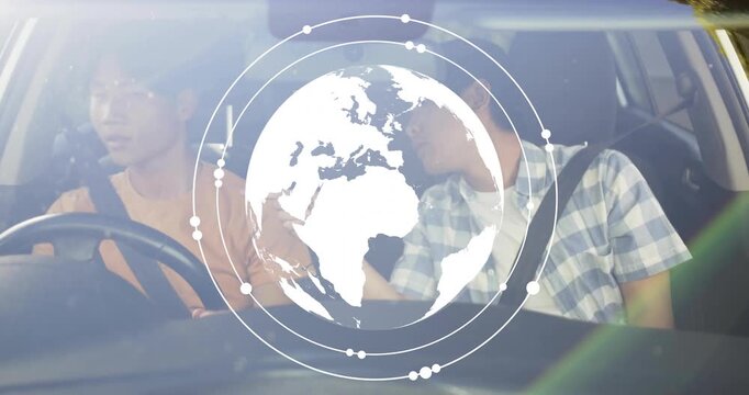 Driver holding wheel and passenger pointing as globe tech appearing expanding after dash touch