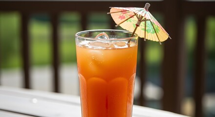 Refreshing summer cocktail with ice and decorative umbrella on a bright sunny day outdoors scene view