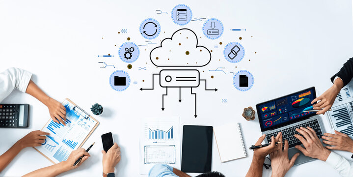 Diverse hands interact with digital devices while illustrating cloud computing and data analysis concepts in a collaborative office environment, showcasing innovation and teamwork. Trope - Powered by Adobe