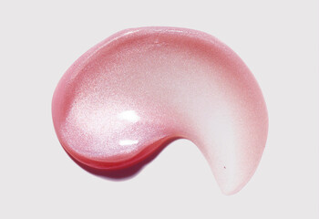 Sparkle micro glitter colored light pink lip gloss smudge swatch isolated on light neutral beige