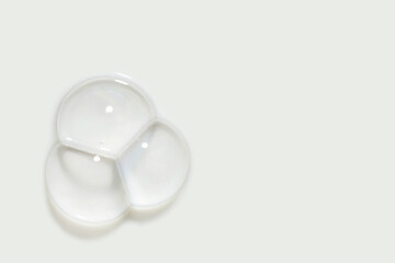 Cosmetic cleansing washing white soapy foam bubbles gel on neutral light milky beige isolated background. Beauty product sample swatch