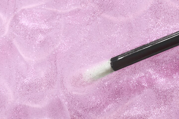 Make up liquid product sample background transparent lip glossy top shimmer translucent glitter with black stick brush 