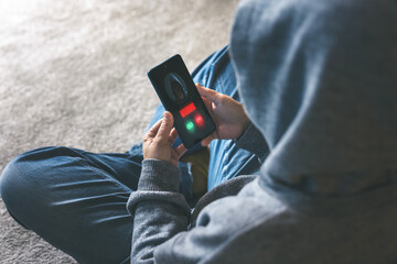 Anonymous Figure Receiving a Critical 'Warning' Call on a Smartphone, Highlighting the Digital...