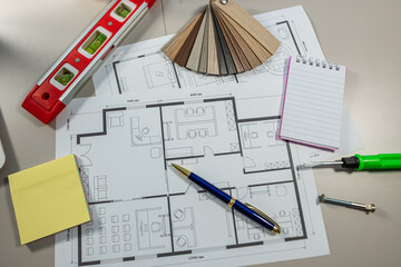 Laptop and house plans on architect table, interior design project, construction planning workspace