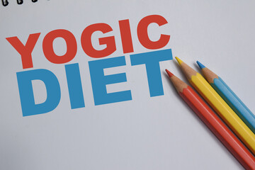 Fototapeta premium Concept of yogic diet write on book isolated on Wooden Table.