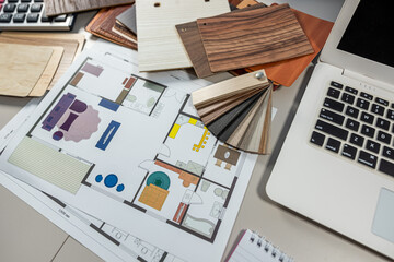 Laptop with color palette and wood samples on architect desk, interior renovation and design project