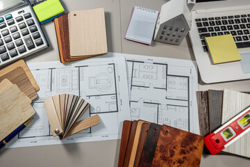 Architect laptop desk with home plan and wood texture samples, decoration and interior project