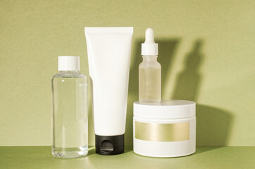 Beauty products no name blank empty space still life on lime green textured paper background. Set of cream, foam or mask, cleansing water or toner, serum. Korean beauty system