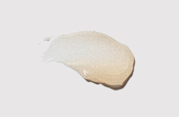 Cosmetic orange shimmering luminous glitter balm gel texture isolated on neutral grey background