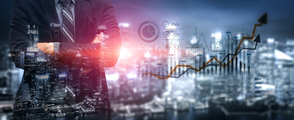 A businessman in a suit stands confidently against a city skyline, with financial graphs overlay...