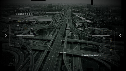 Fototapeta premium Aerial surveillance, military reconnaissance view of a complex highway interchange with HUD targeting graphics, creating a cinematic spy-drone atmosphere and intelligence-operation mood