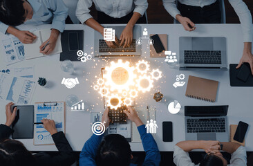 A dynamic collaborative business meeting featuring diverse professionals engaged with technology, analyzing data, and visualizing strategies for innovative development and growth. Trope