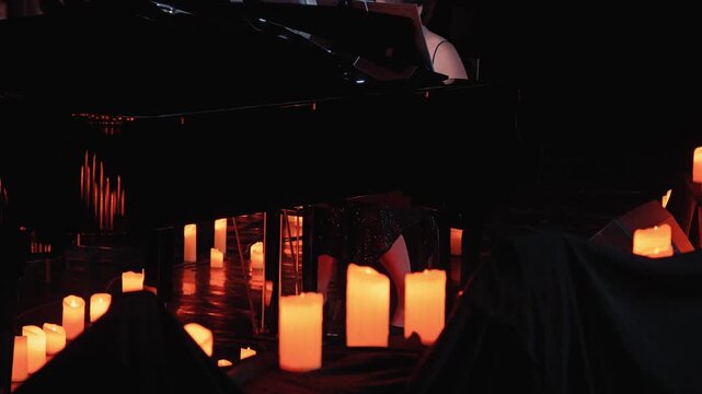The atmosphere of a dimly lit performance space, featuring a pianist with flickering candles surrounding the piano, creating a serene and enchanting environment. Concert by candlelight