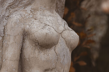 Cracks on a female statue as a symbol of breast cancer prevention. Women's health. Breast cancer....