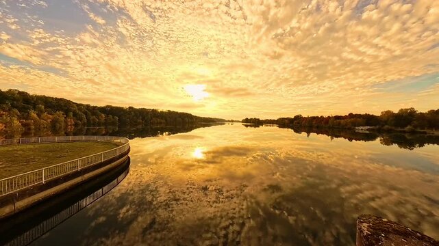 4K Timelapse video with moving clouds and reflections near sunset or sundowner at Zulling, Landau, river Isar, Dingolfing, Bavaria, Germany