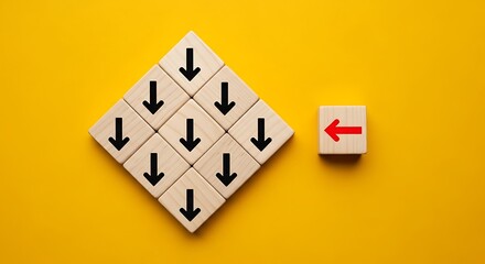 Wooden blocks with arrows pointing down and one pointing left on yellow