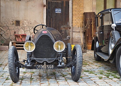 Bugatti vintage race car parked on cobblestone street