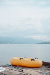 Fototapeta premium double inflatable float on a dock on a beautiful lake surrounded by mountains