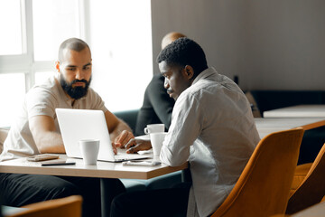 Collaborative Business Meeting with Mixed Ethnicity Team in Modern Office Setting