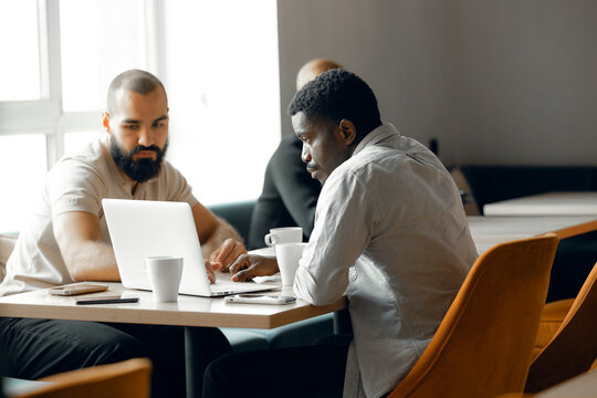 Collaborative Business Meeting with Mixed Ethnicity Team in Modern Office Setting
