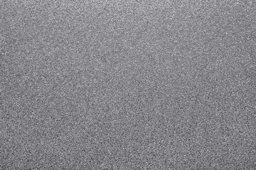 Silver glitter creating textured, shimmering surface. Background offering sparkling, abstract and metallic feel for design