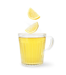 Citrus drink for health boosting. Lemon pieces falling into cup on white background. Cold season remedy