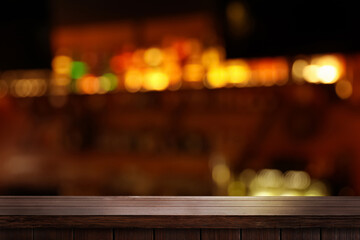 Empty wooden table against blurred background. Space for design