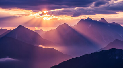 Dramatic mountain landscape with sun rays and clouds at sunset
