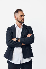 A business professional man stands with arms crossed, radiating confidence and focus. On an isolated colored background, he conveys determination, calm control, and leadership, ready to tackle tasks