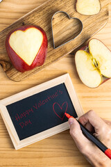 Hand writing a romantic message on a chalkboard