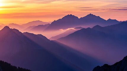 Scenic mountain range with sunlight and mist at golden hour