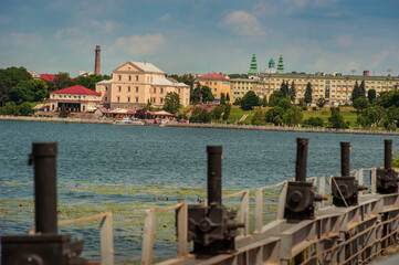 Ternopil city, Ukraine, landscape with silhouettes of buildings over the lake from the old dam