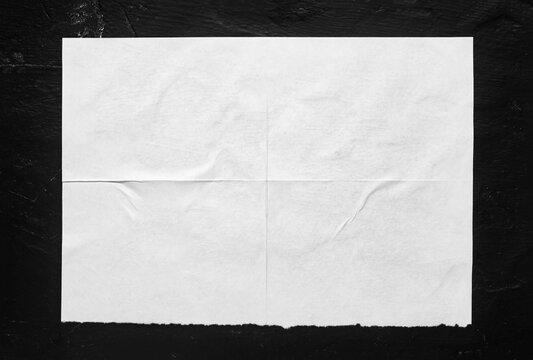 white poster with folds on a black background