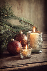 Christmas candles and ornaments on rustic wooden table