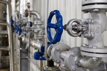Pipe line valve, steel pipelines and tubes at brewery, selective focus