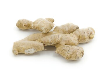 Organic ginger root resting on white surface.