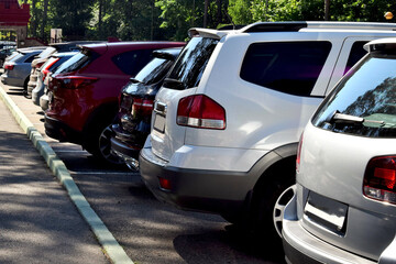 A parking lot filled with cars. A view of the cars from behind. © dzmitry_2014