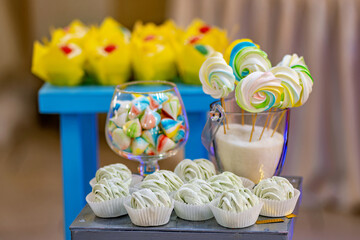 A table topped with cupcakes and lollipops on top of a table