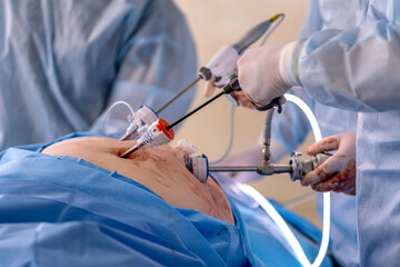A surgeon is performing an operation on a patient's face