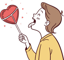 Boy enjoying a heart shaped lollipop - stock media - (60 chars)