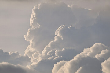A beautiful fluffy clouds on sunny day with dramatic golden hour sky background.
