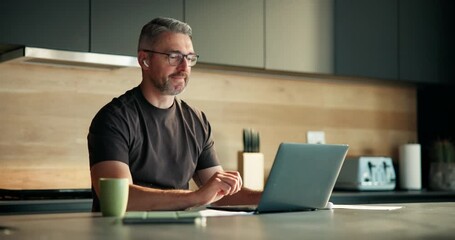 Video call, online and man with laptop in kitchen, virtual assistant or communication with earphones. Talking, mature person and financial review with client on website, digital consultation and home - Powered by Adobe