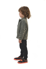 side view of  boy dressed in sportswear standing on white background