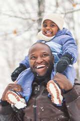 father and child boy in winter forest with parents and kids love relationship having warm clothes for cold climate