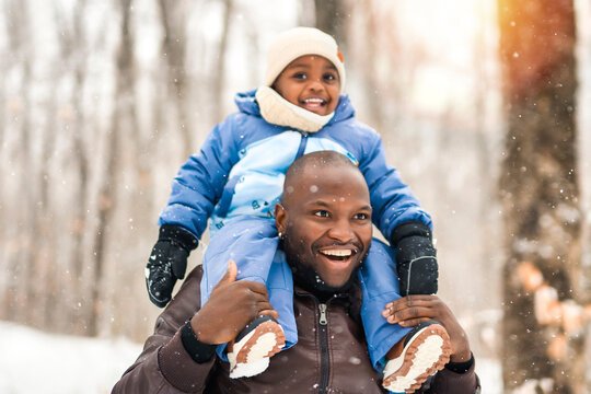 father and child boy in winter forest with parents and kids love relationship having warm clothes for cold climate - Powered by Adobe